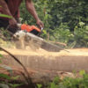 A chainsaw cuts through timber near Afi River Forest Reserve. Image by Orji Sunday.