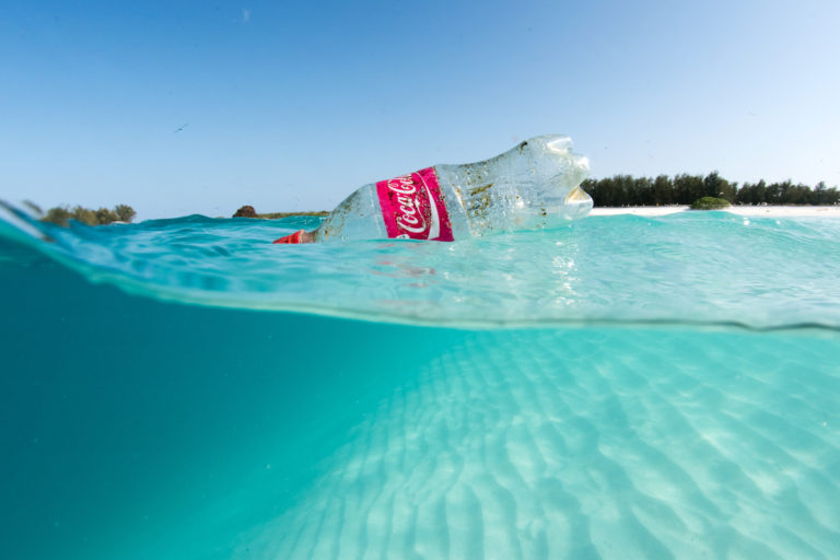 A plastic beverage bottle floats in the shallow waters of Sand Island in Hawaii. Image by David Slater / NOAA Coral Reef Ecosystem Program Marine Debris Team, 2015.