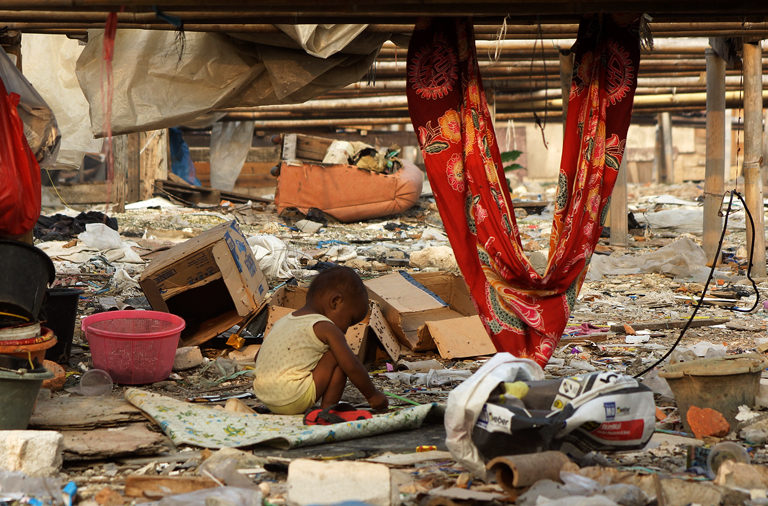 A child is playing among waste and rubbish in the Muara Angke area, North Jakarta in April 2018. 