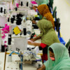 Tailors are seen working on a production line in a local garment factory in Bangladesh.