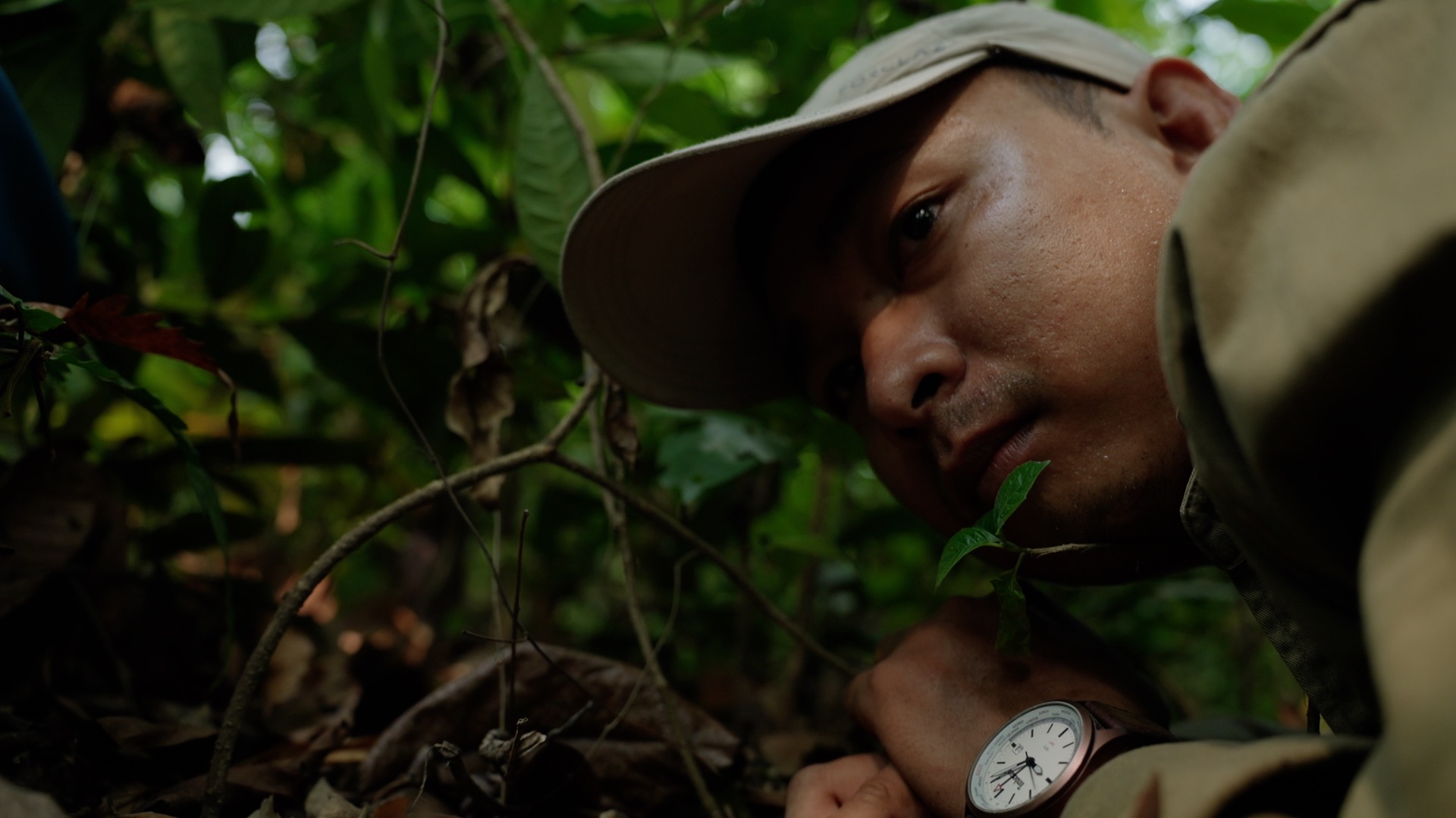 Veteran Cambodian environmentalist San Mala hides from Ministry of Environment rangers that aimed to detain him in Chhaeb-Preah Roka Wildlife Sanctuary in April 2023. Image by Chasing Deforestation / Mongabay.