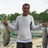 Fisherfolk leader Lorene Gabayeron holding fish.