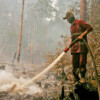 A firefighter puts out fires in a peatland in Indonesia.