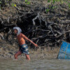 A fisherman collects shrimp in Khulna, Bangladesh.