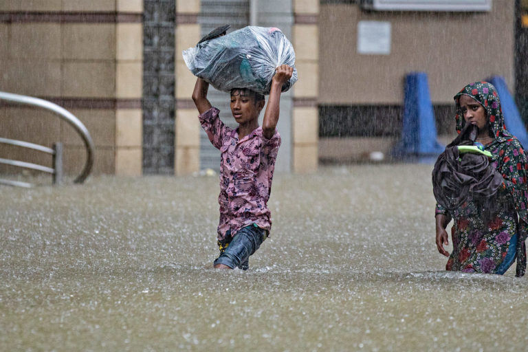 People wading through water.