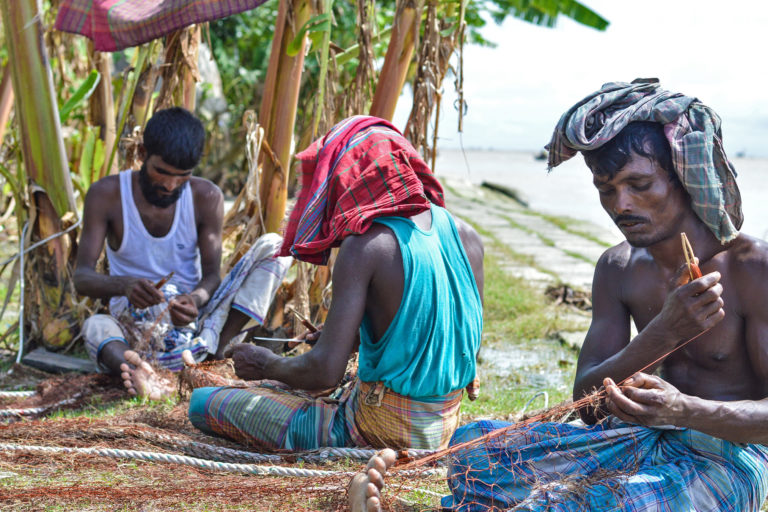 Fishermen making hilsa nets.