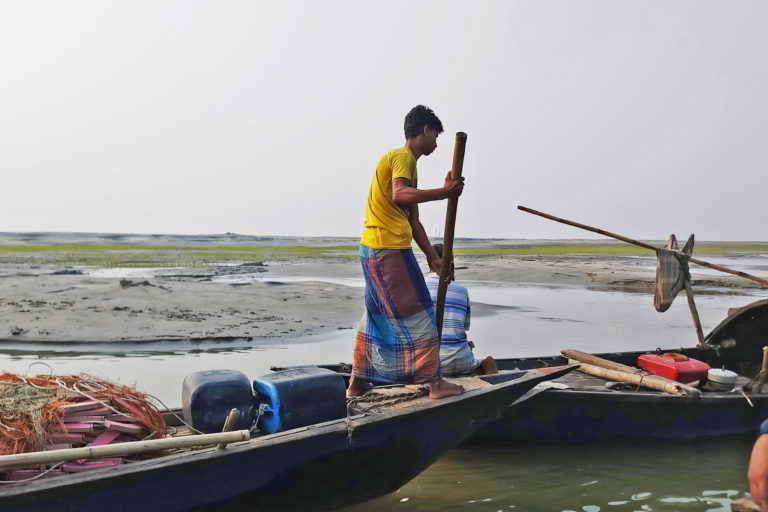 Fishermen going out to the river