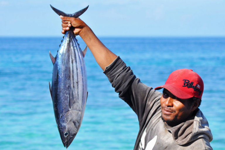 A Maluku fisherman shows his catch of skipjack tuna.