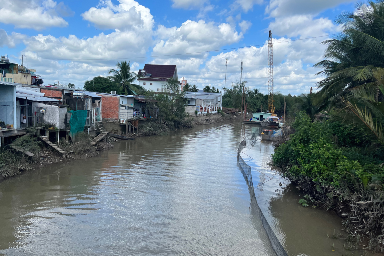 Houses and businesses line the banks of dikes and rivers in the Mekong delta in Vietnam.