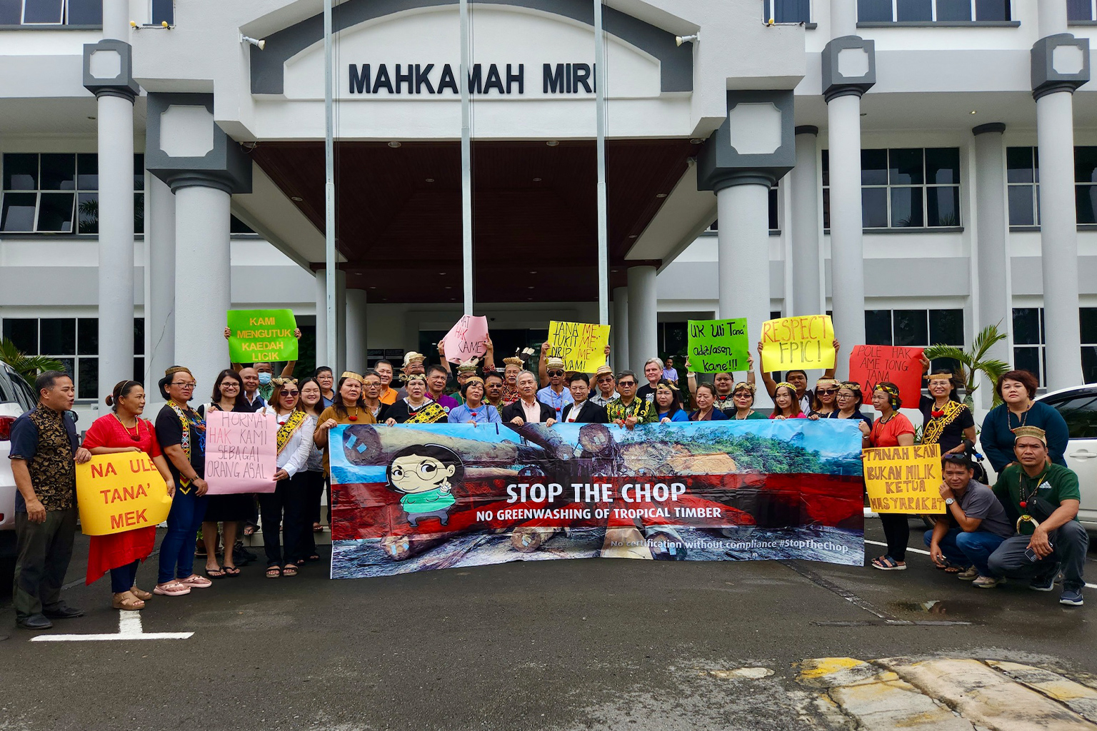 Community members celebrating their victory at the Miri High Court with the Stop The Chop banner. 