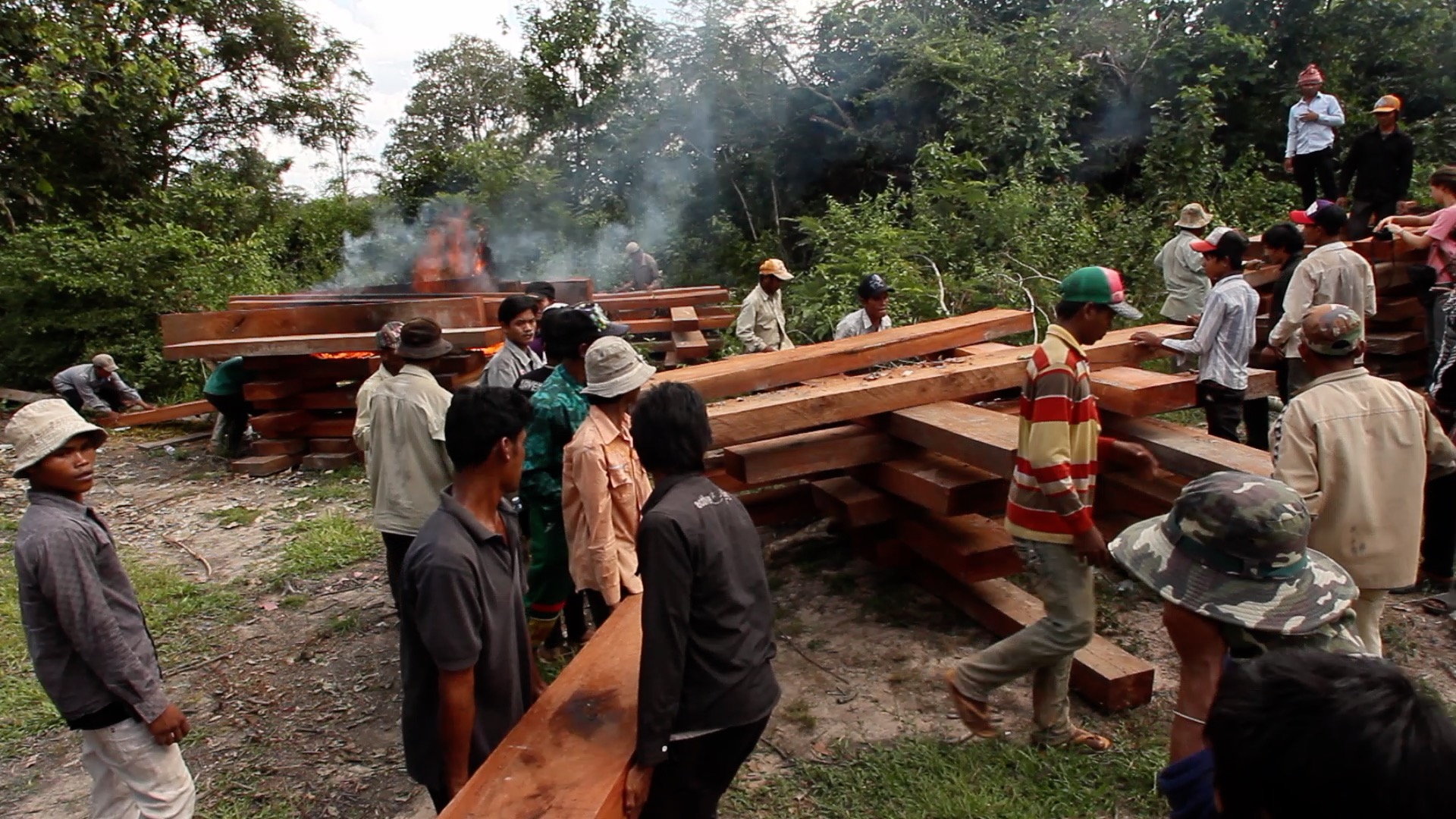 In 2011, members of the Prey Lang Community Network, a grassroots activism group intent of preserving the protected area, burn an unmarked stockpile of illegal timber shortly before local authorities attempt to arrest the late forest activist Chut Wutty. Image supplied. 
