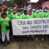 Members of Synaparcam, an association of communities affected by Socapalm holding a banner reading "YES to the respect of community rights" in French. Image courtesy Thierry Didier Kuicheu
