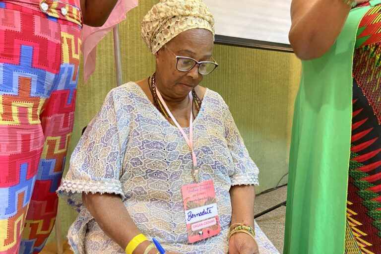 Maria Bernadete Pacífico [looking down] was the leader of Pitanga of Palmares quilombo, located in Bahia state. Here she is at the CONAQ National Women's Meeting. Image courtesy of CONAQ.